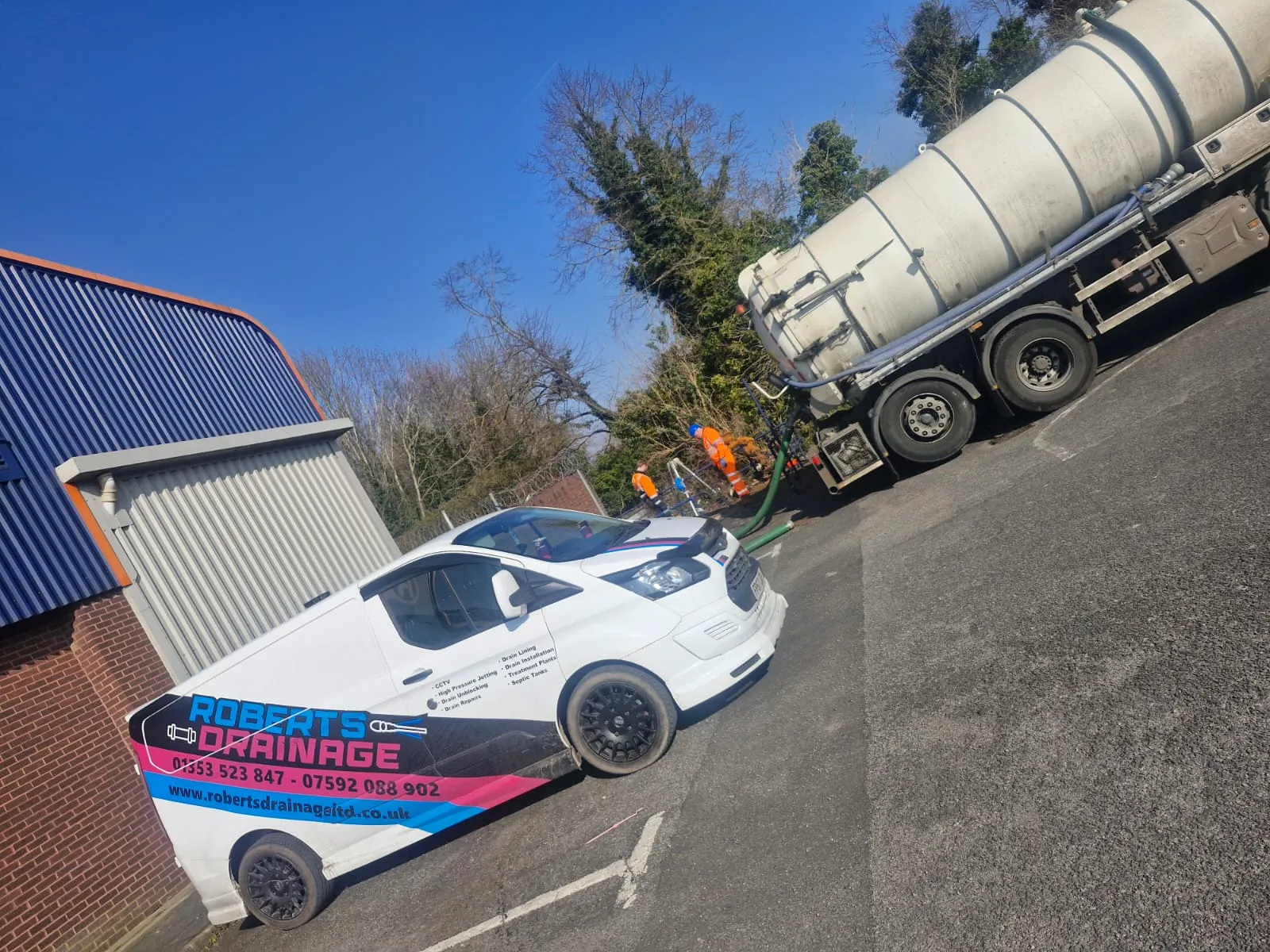Roberts Drainage Ltd van and vacuum tanker on-site for professional liquid waste management and commercial drainage services.
