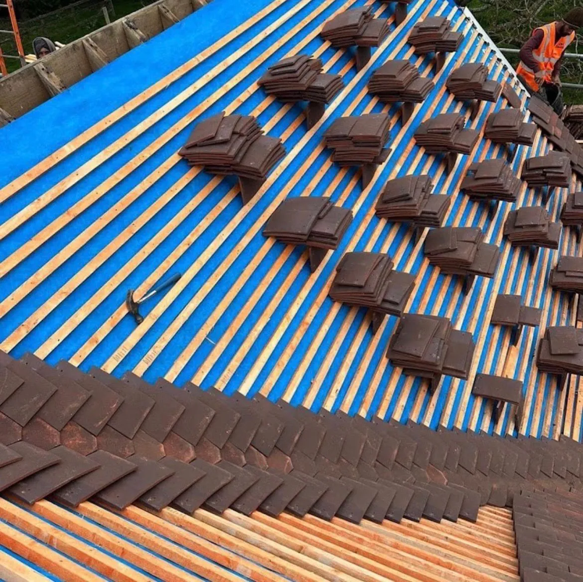 Pitched roof replacement showing breathable membrane, timber battens, and tile installation