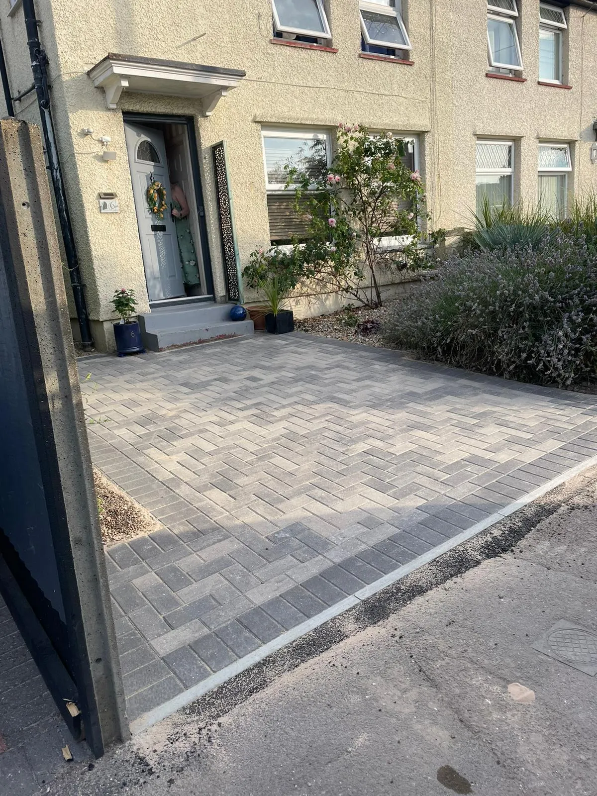 Newly installed grey block paving driveway with a herringbone pattern by Kent Paving & Resin LTD.