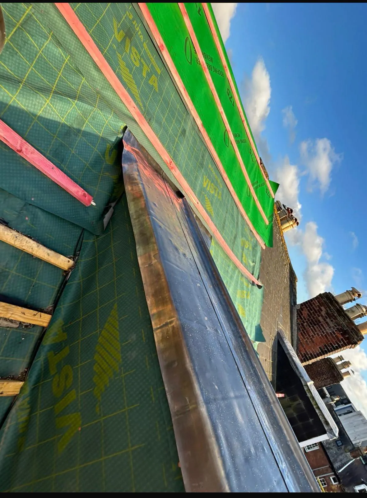 Code 4 lead valley flashing installed on roof rafters with breathable underlay membrane