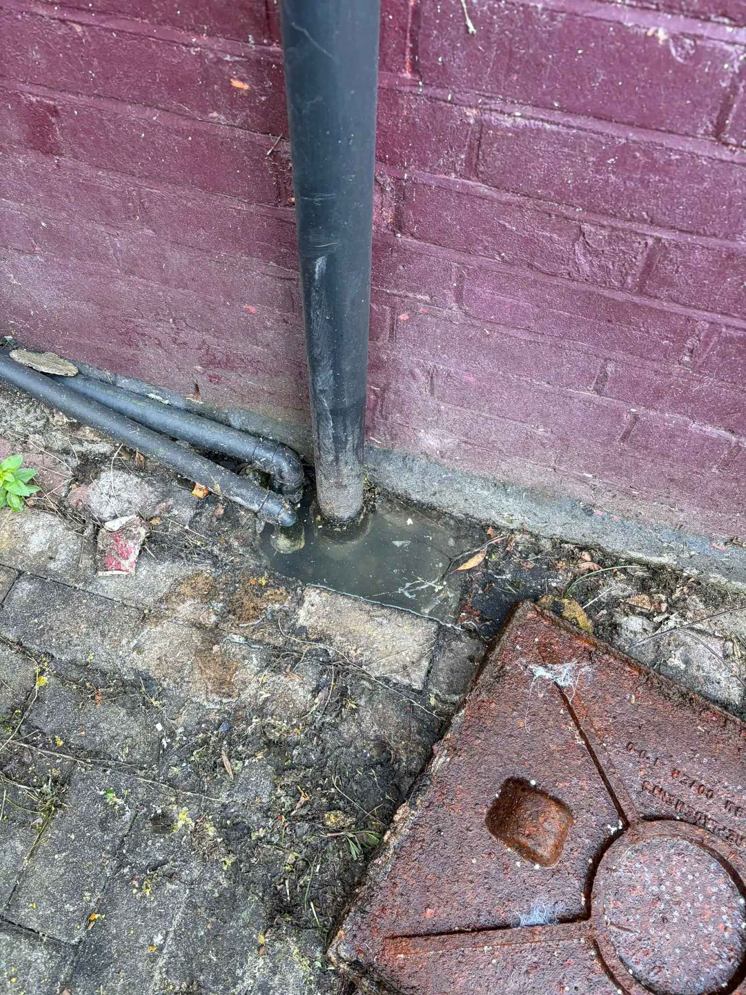 Blocked outside drain showing standing water requiring emergency unblocking in Slough
