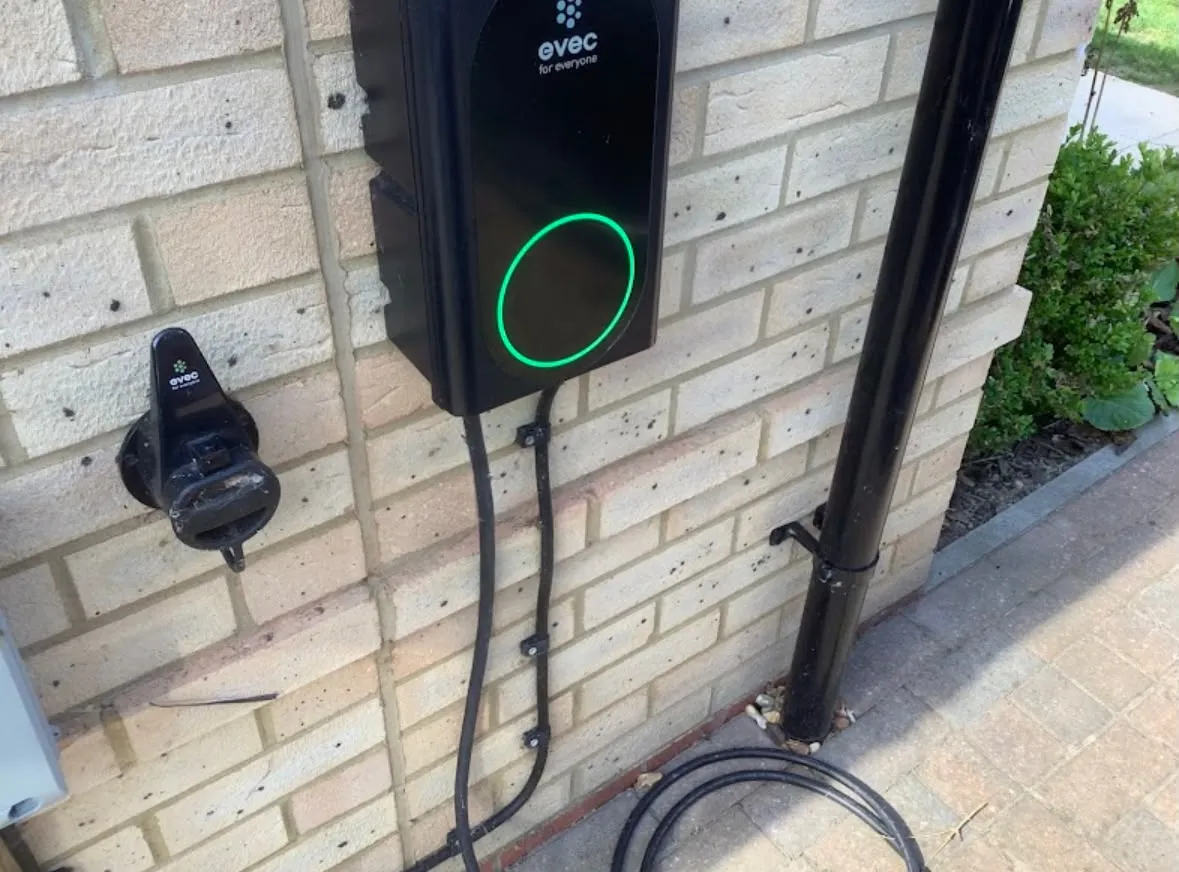 Domestic EV charger installation on an exterior brick wall by Sussex Brown Sparks