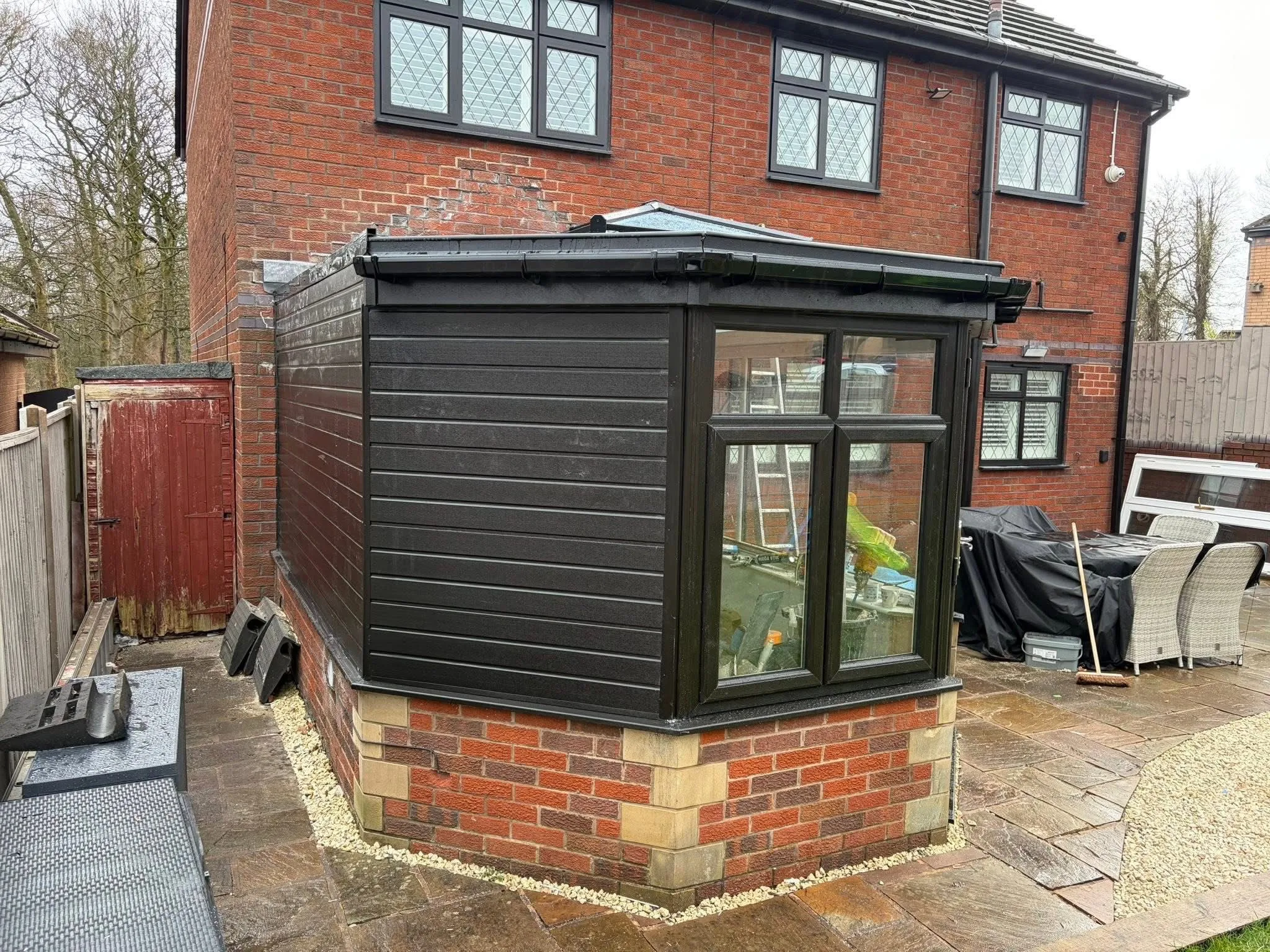 Modern solid conservatory roof conversion with black cladding in Lancashire