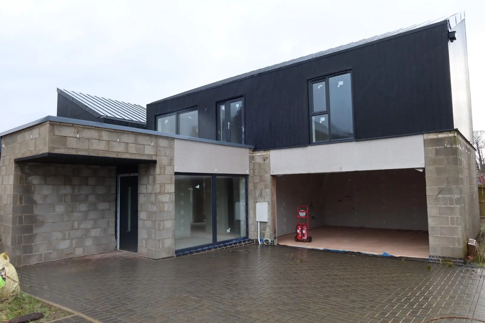 Modern detached property undergoing external wall insulation and rendering preparation over solid blockwork by Global Plastering in South Wales