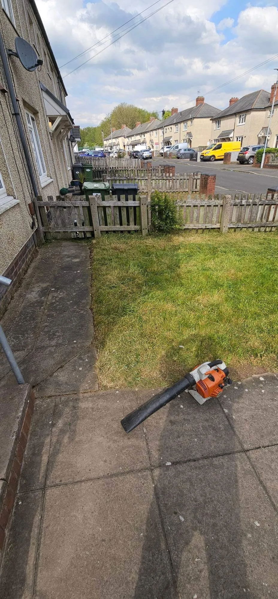 Front garden lawn mowing and garden maintenance tidy-up with a leaf blower outside a Birmingham property