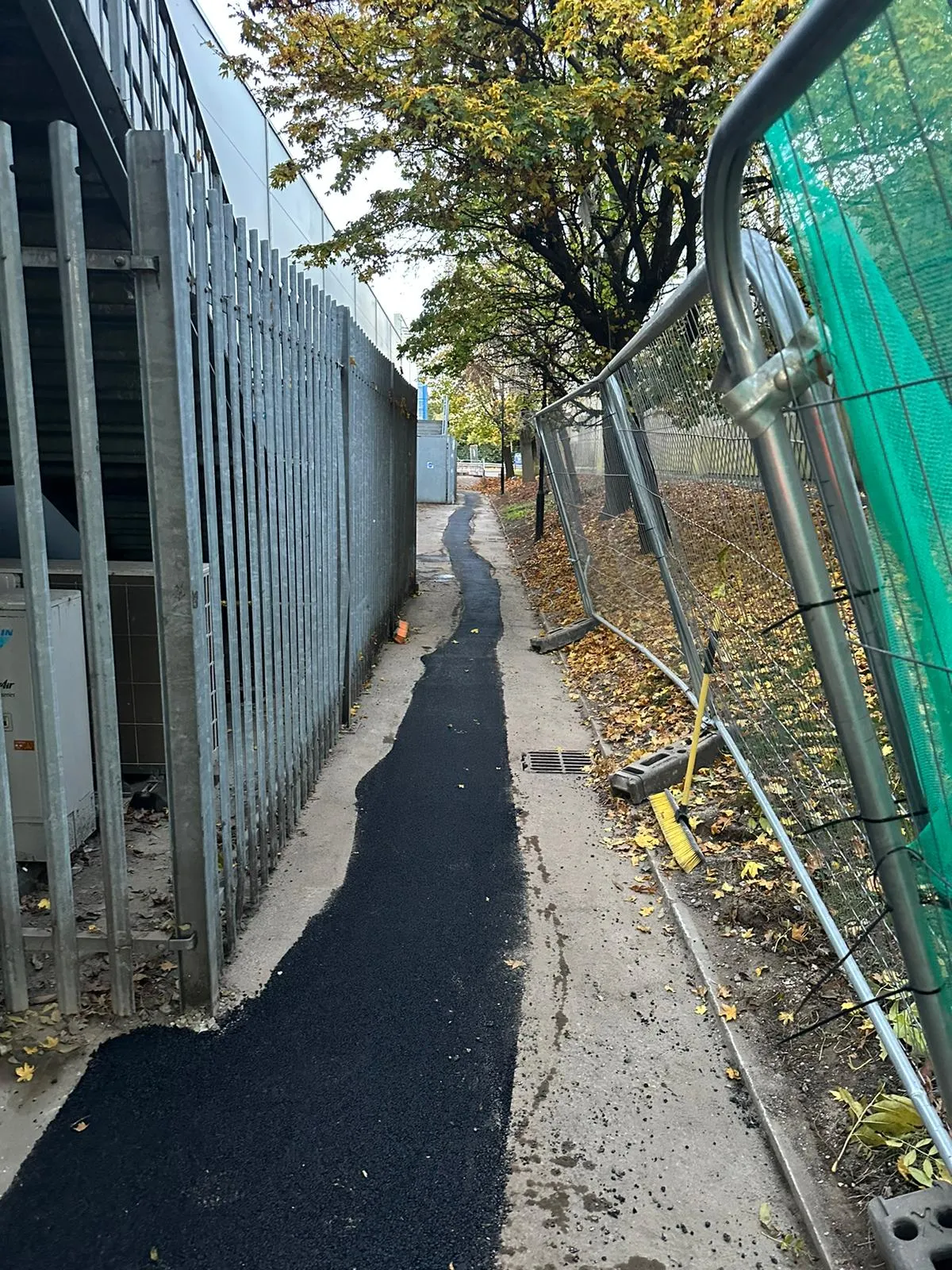 Fresh tarmac reinstatement on a narrow path after civils work by Roberts Drainage Ltd