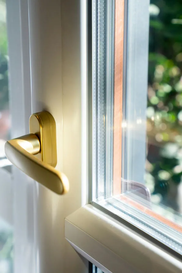 Close-up of an energy-efficient double-glazed uPVC window with a gold handle