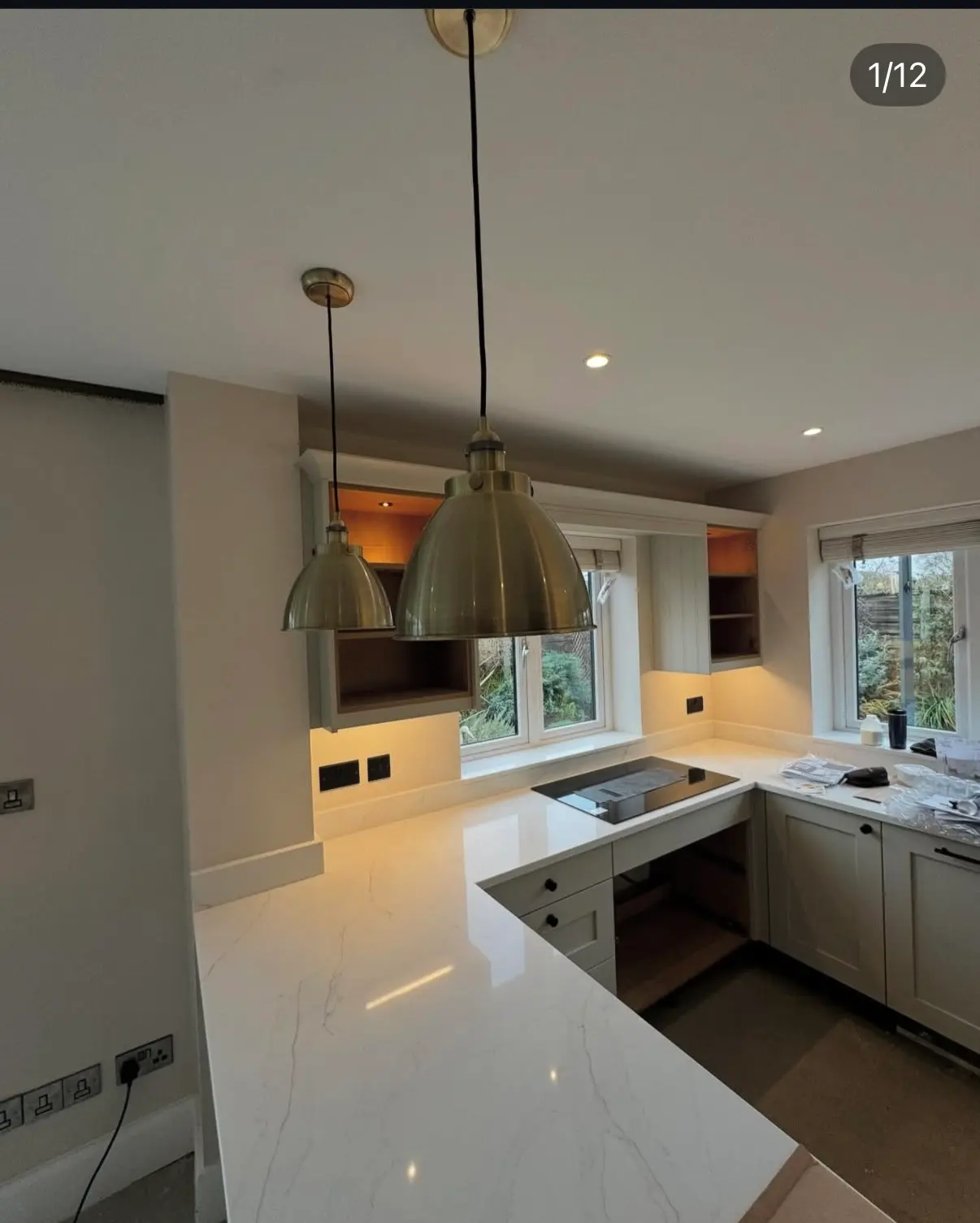 Expert kitchen rewiring and modern lighting installation in Warrington, featuring brass pendant lights and LED spotlights by JH Electrical Contractors Ltd