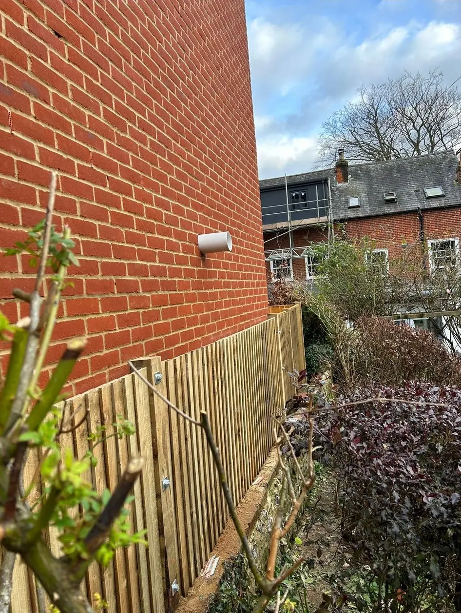 Newly constructed red brick exterior wall and bespoke wooden garden fencing installation