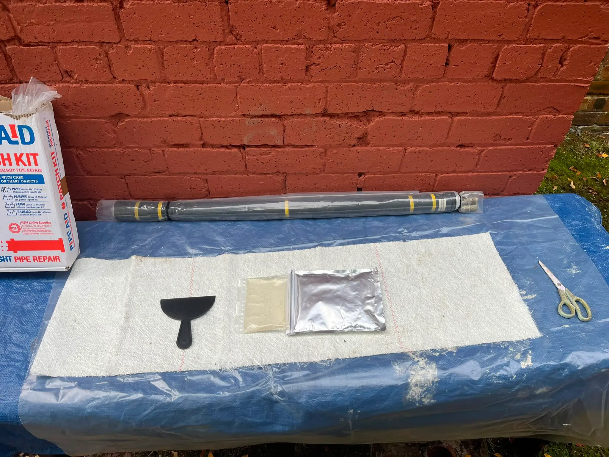 A Pipe Aid patch kit and materials prepared for a no-dig drain repair by CB Drainage