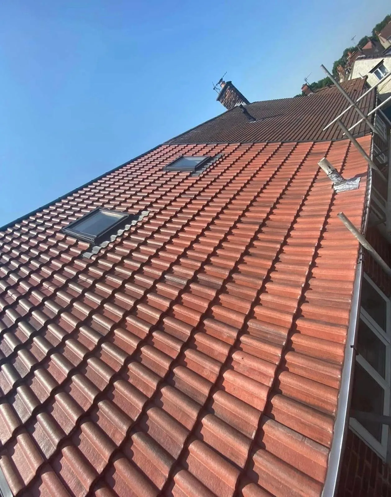 A newly installed tiled roof with skylights and scaffolding in Nottingham