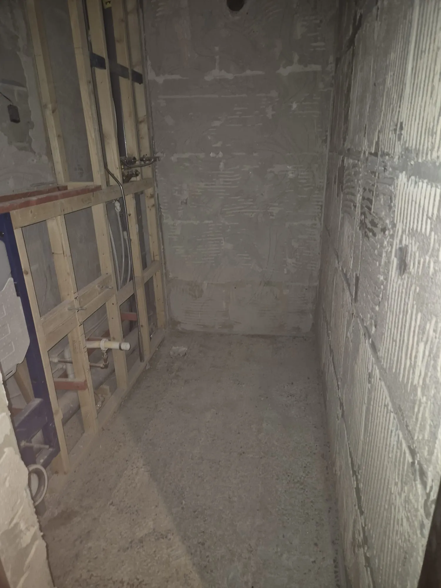 Bathroom renovation with new timber stud frame for concealed cistern and pipework, walls prepped for finish.