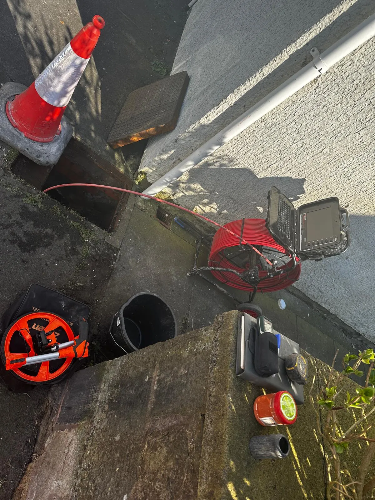 CCTV drain survey in progress, showing camera equipment and an open manhole