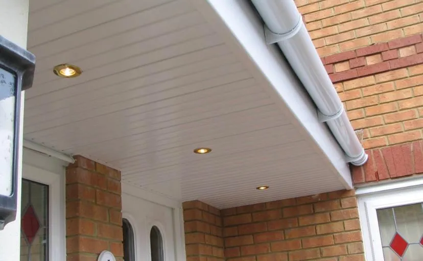 Close-up of new white UPVC soffits with spotlights and matching guttering