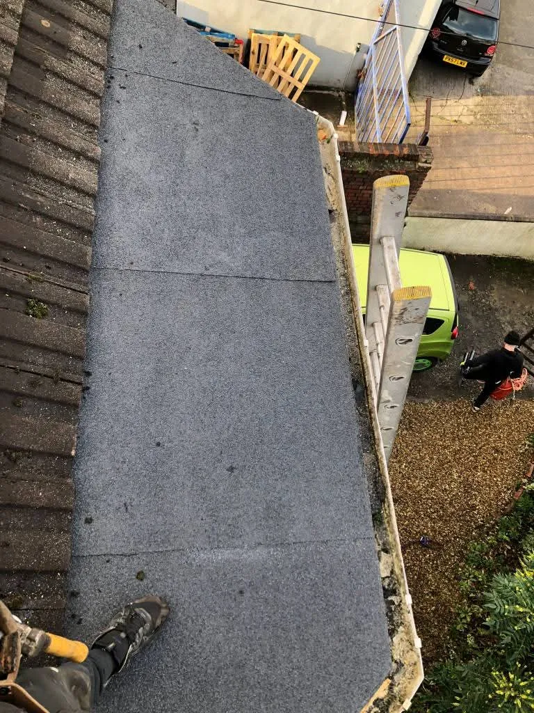 Expert installation of a durable felt flat roofing system on a residential bay window by NTL Roofing specialists.