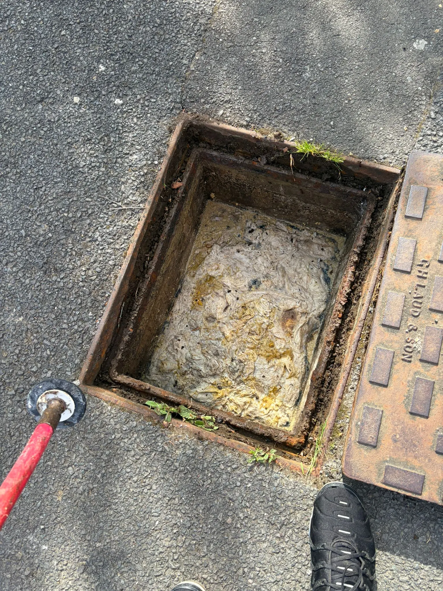 Severe outdoor drain blockage in Slough being inspected for emergency unblocking