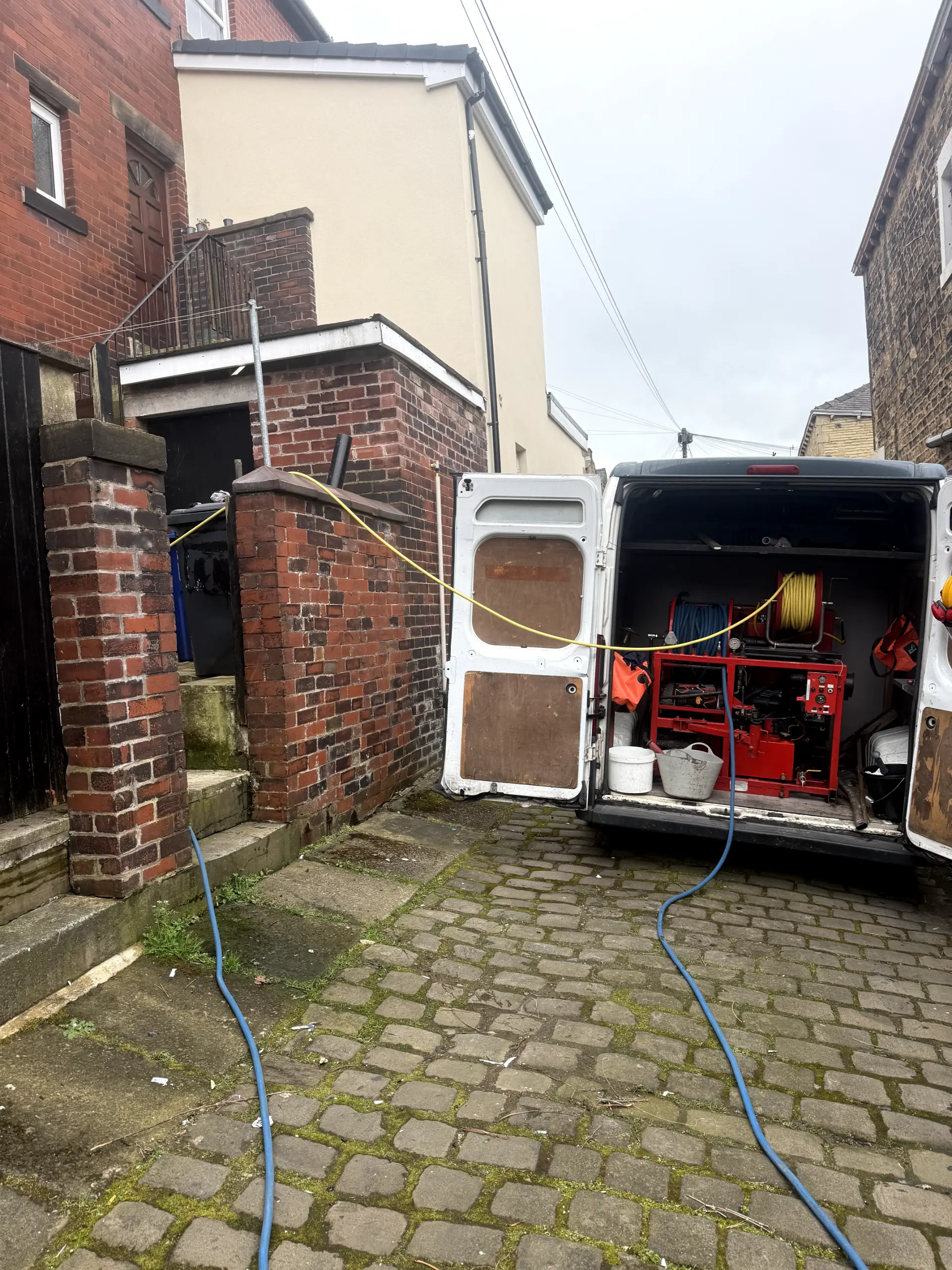 WGS Services van with high-pressure water jetting equipment unblocking a residential drain in Darwen.