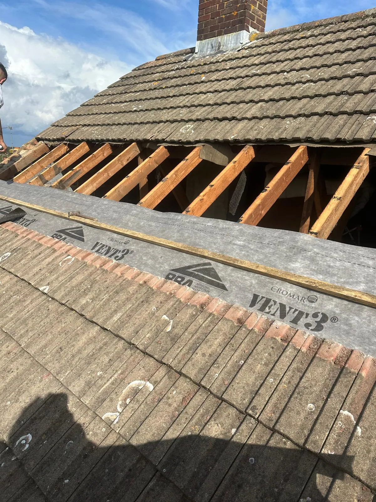Professional roof repair in Kent showing exposed rafters and new breathable membrane installation by First Choice Roofing Kent.
