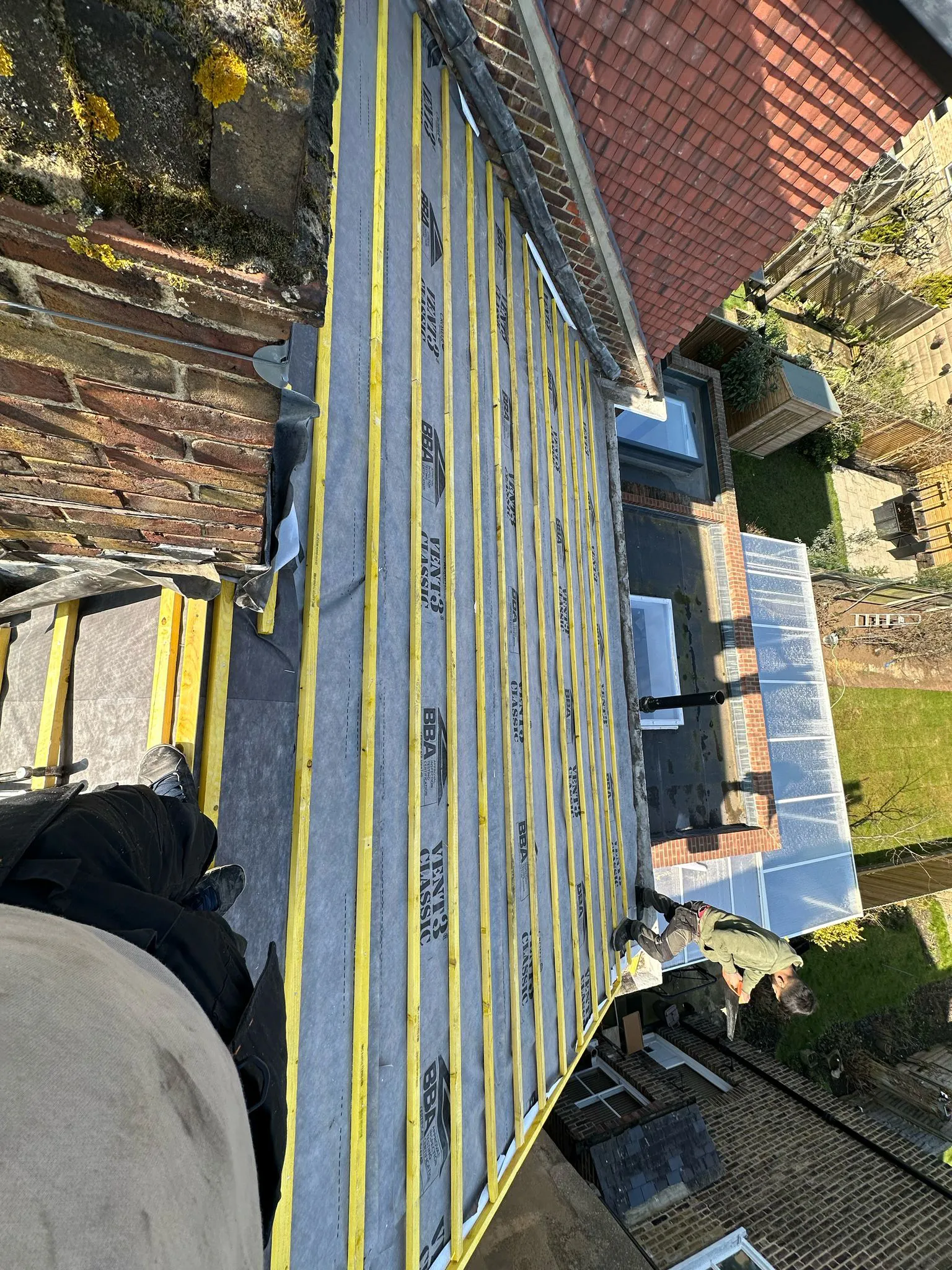 Treated roofing battens and breathable membrane fitted to pitched roof rafters during a re-roof installation