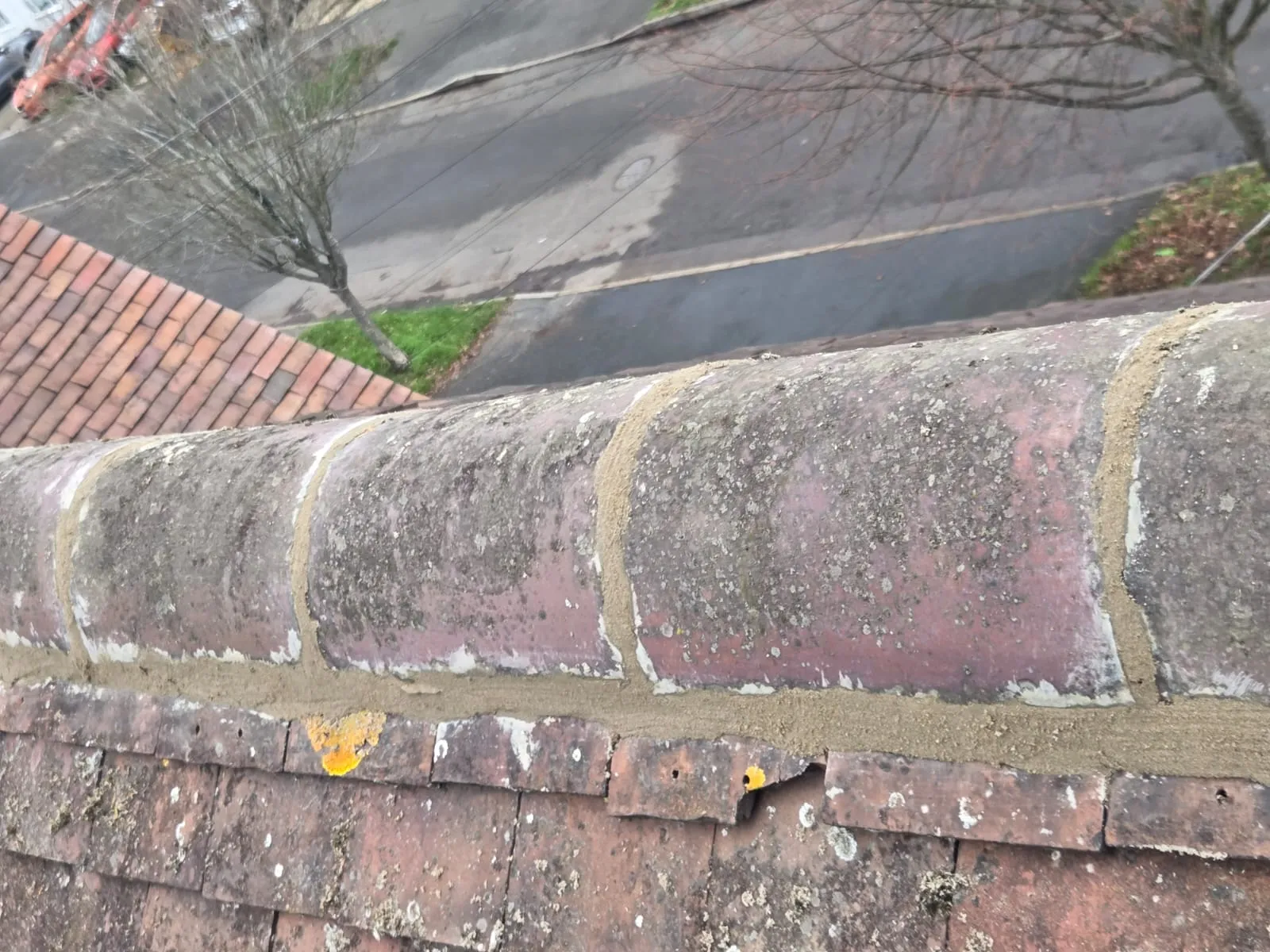 Freshly repointed ridge tiles on a tiled roof, part of a professional roof repair service in Cornwall.