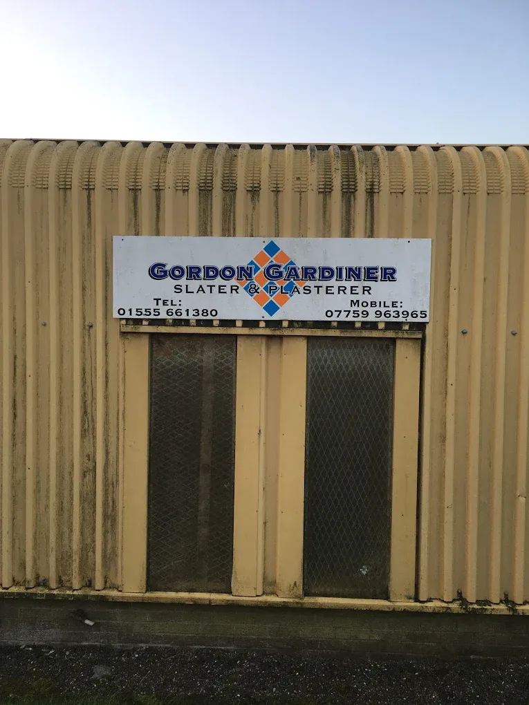 Gordon Gardiner Slater & Plasterer business sign on a building in Lanark