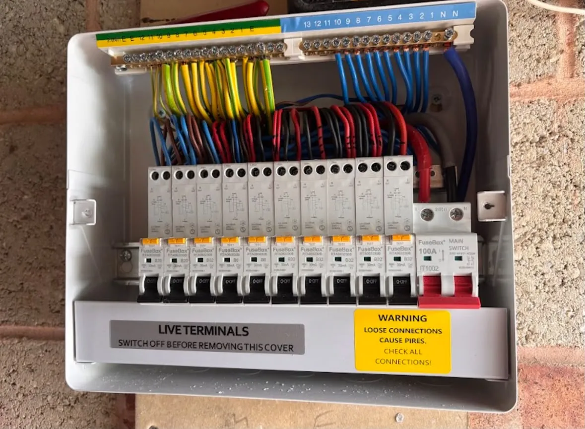Modern metal-clad RCBO consumer unit installation showing neat internal wiring and safety warning labels