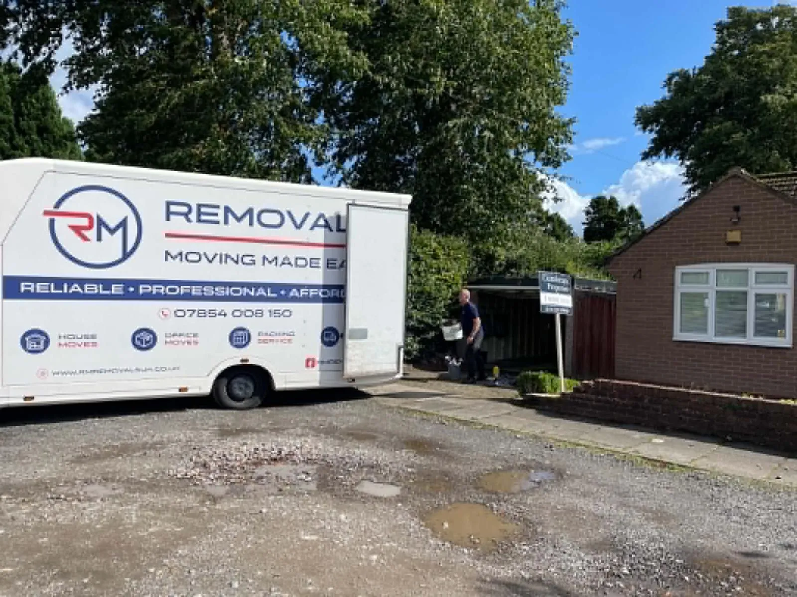 RM Removals van parked on a residential driveway during a house move
