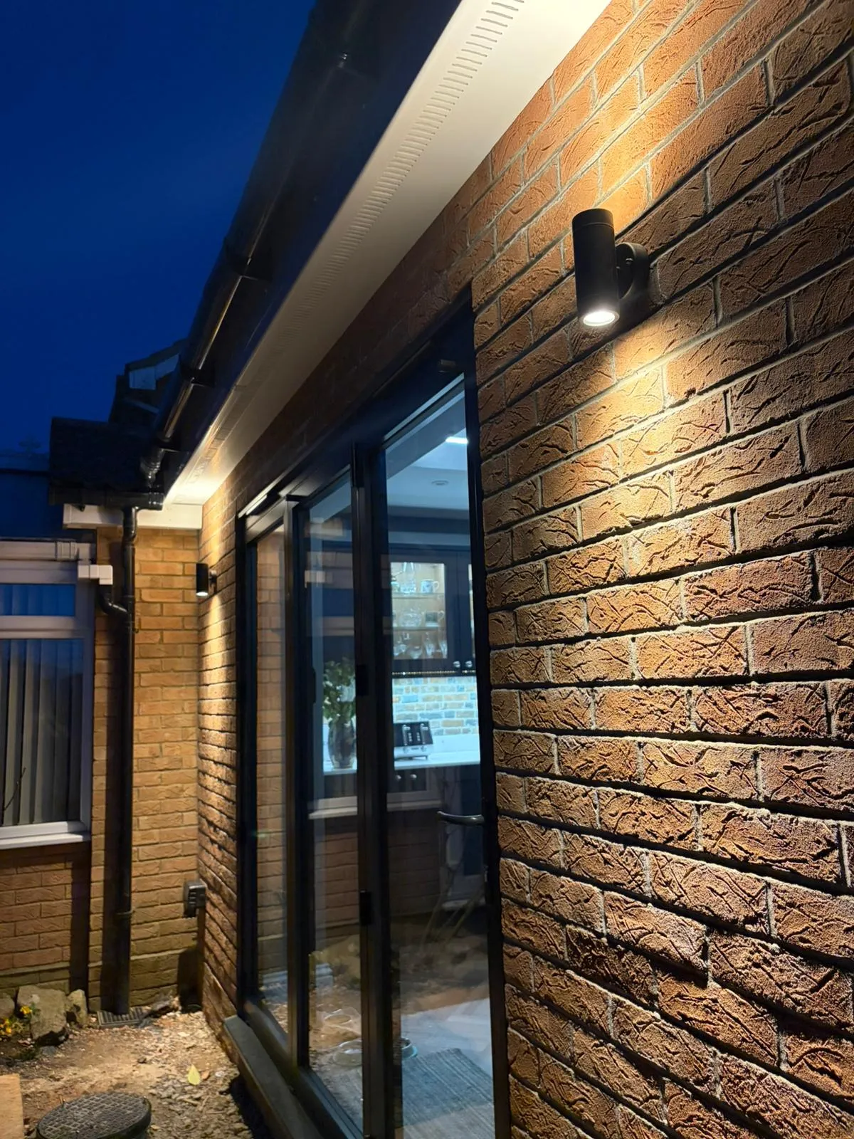 Professional outdoor wall light installation on a brick house in Felixstowe by NICEIC approved electricians