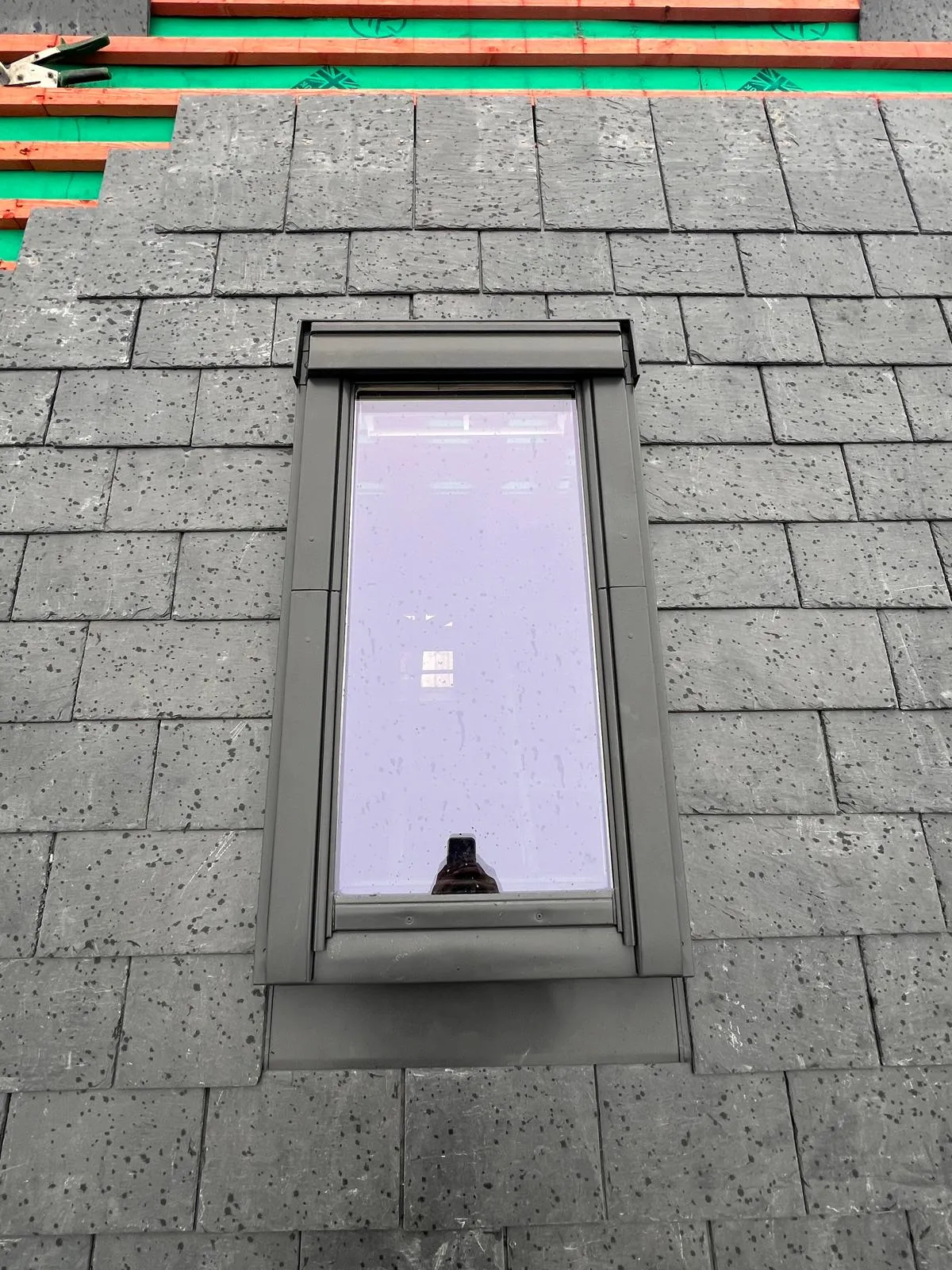 Close-up of a new Velux roof window installation on a pitched slate roof, demonstrating DSR Roofing York's expertise in roof window fitting and slate roofing in York.