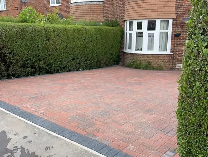 A new block paved driveway in a herringbone pattern in front of a house in Canterbury, Kent.