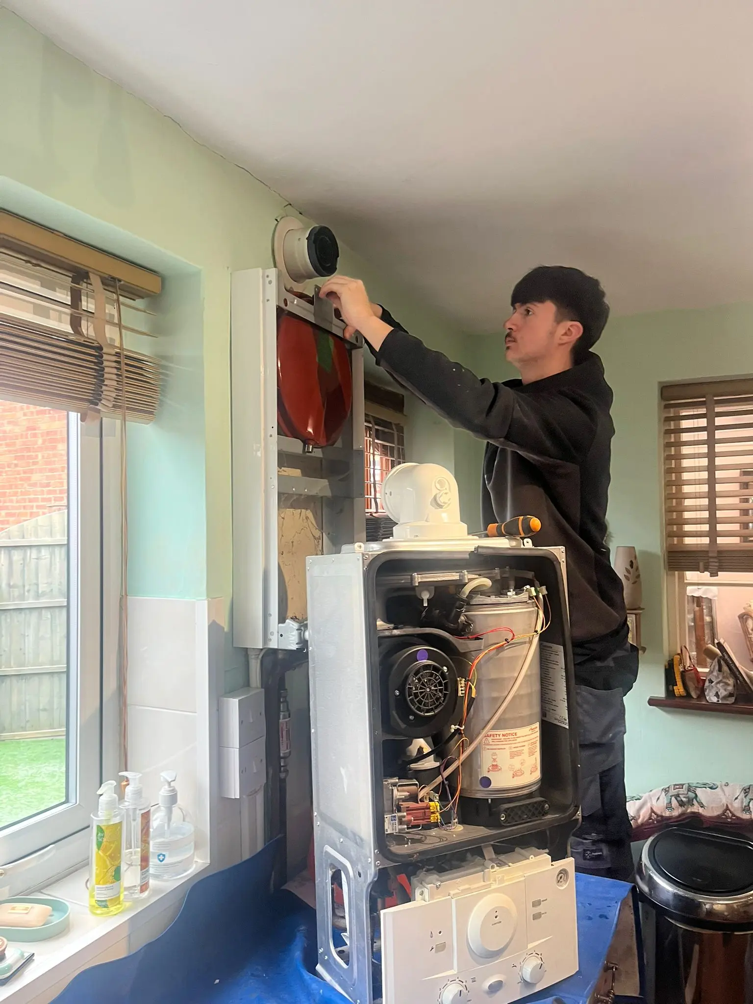 Gas Safe registered engineer from Fact Services installing a high-efficiency boiler in a Wolverhampton home.