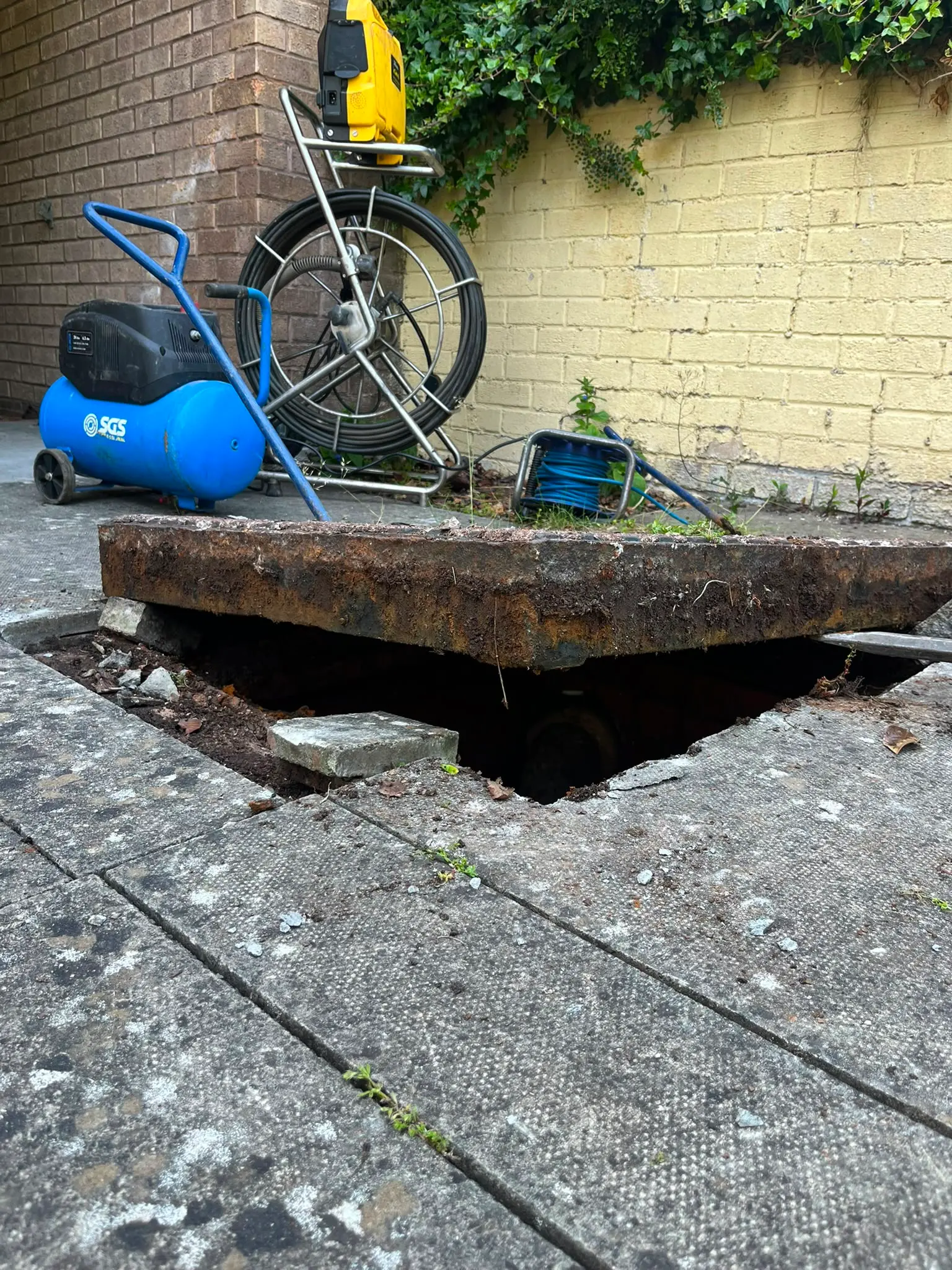 CB Drainage professional CCTV drain survey equipment prepared for a pipeline inspection beside an open manhole