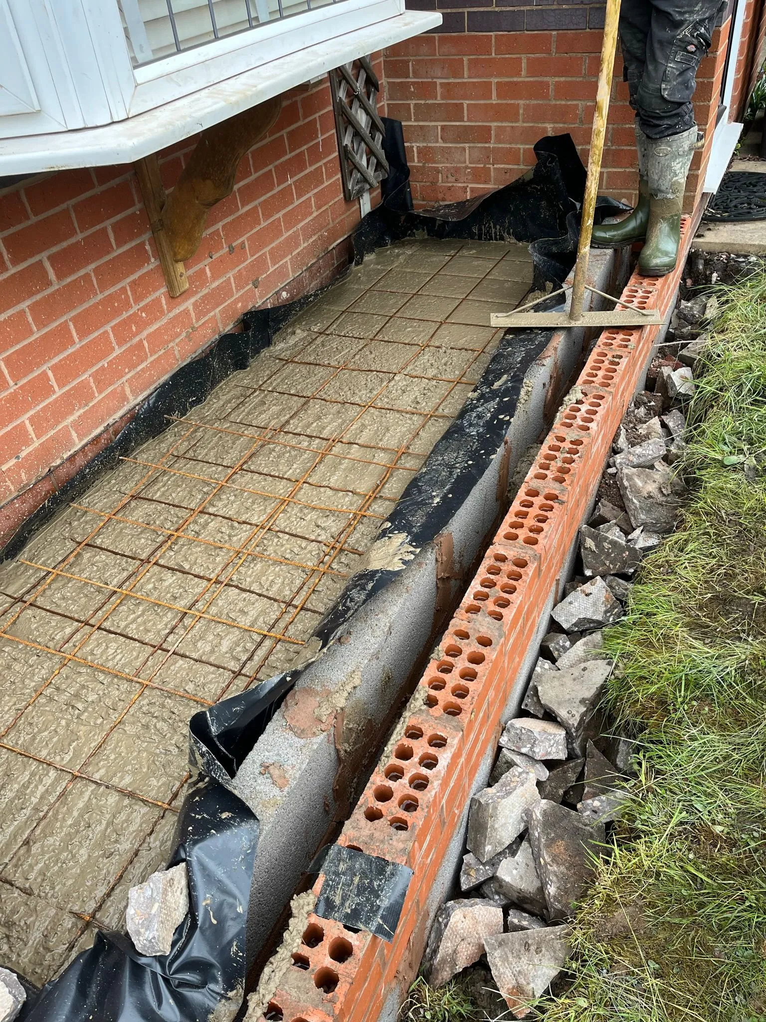 Concrete foundation with rebar being laid for a home extension
