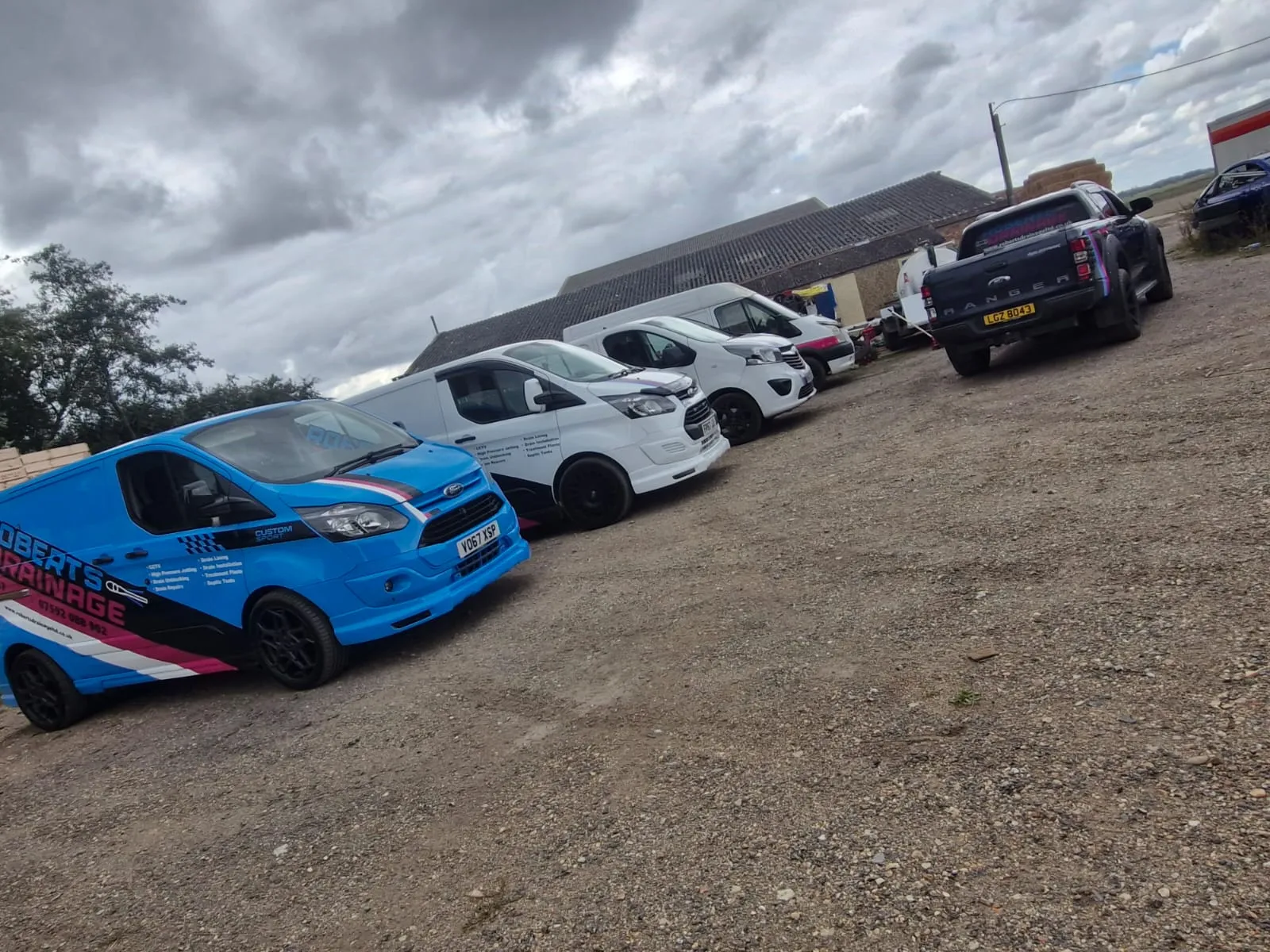 Fleet of Roberts Drainage Ltd branded service vehicles and vans
