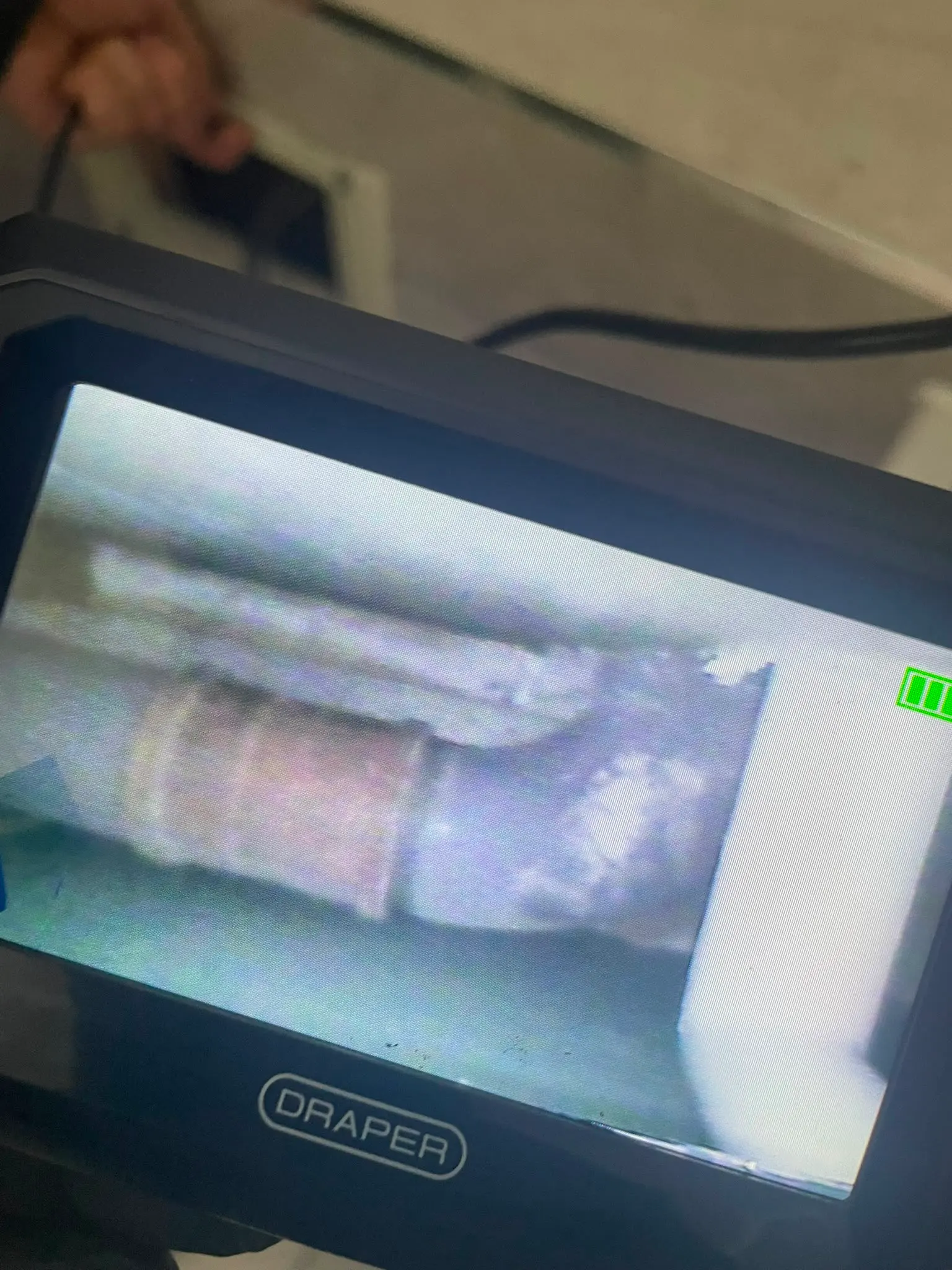 Draper inspection monitor showing a CCTV drain survey inside a pipe