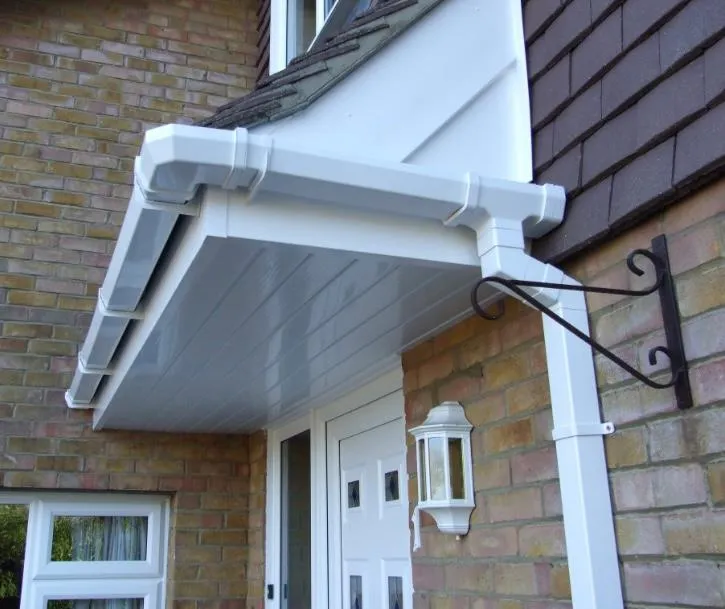 A close-up of a house with new white UPVC fascias, soffits, and guttering around a porch entrance.