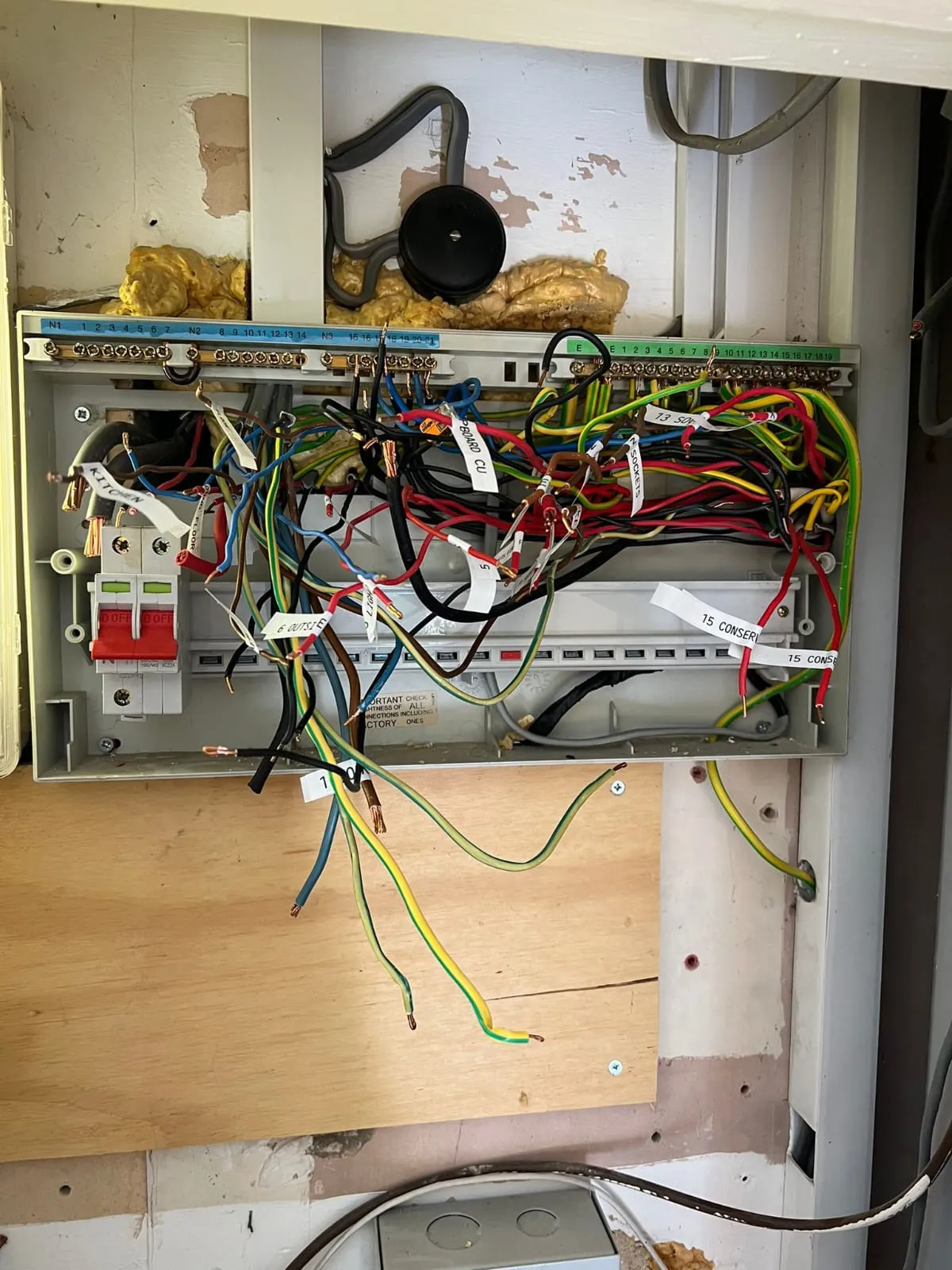 Messy electrical wiring and exposed circuits inside a consumer unit requiring professional fault finding in Felixstowe.