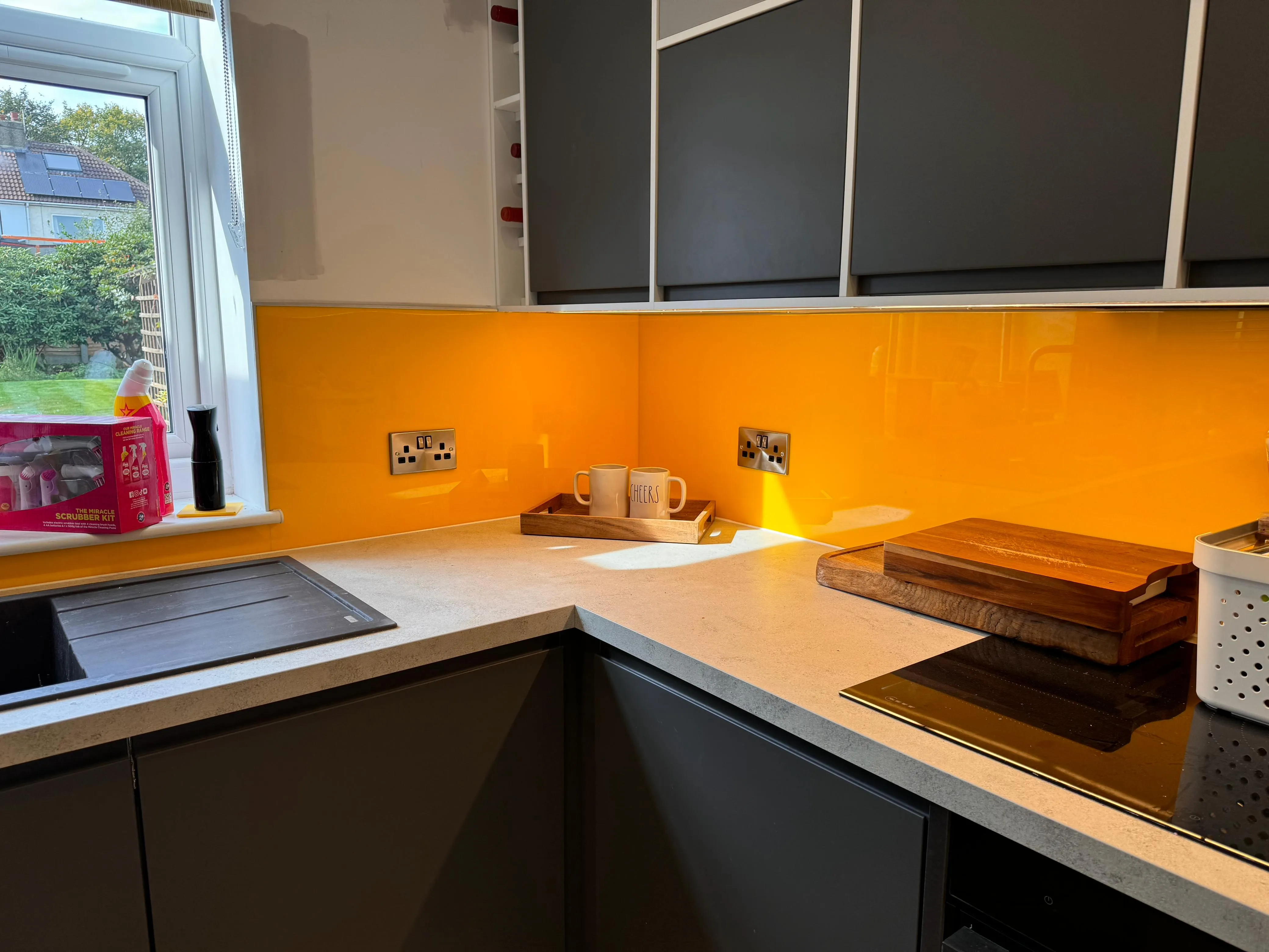 Professional installation of chrome double sockets in a modern kitchen with an orange splashback in York.
