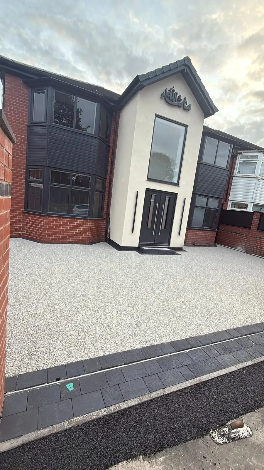 Modern light-grey resin bound driveway with block paving borders by Kent Paving & Resin LTD