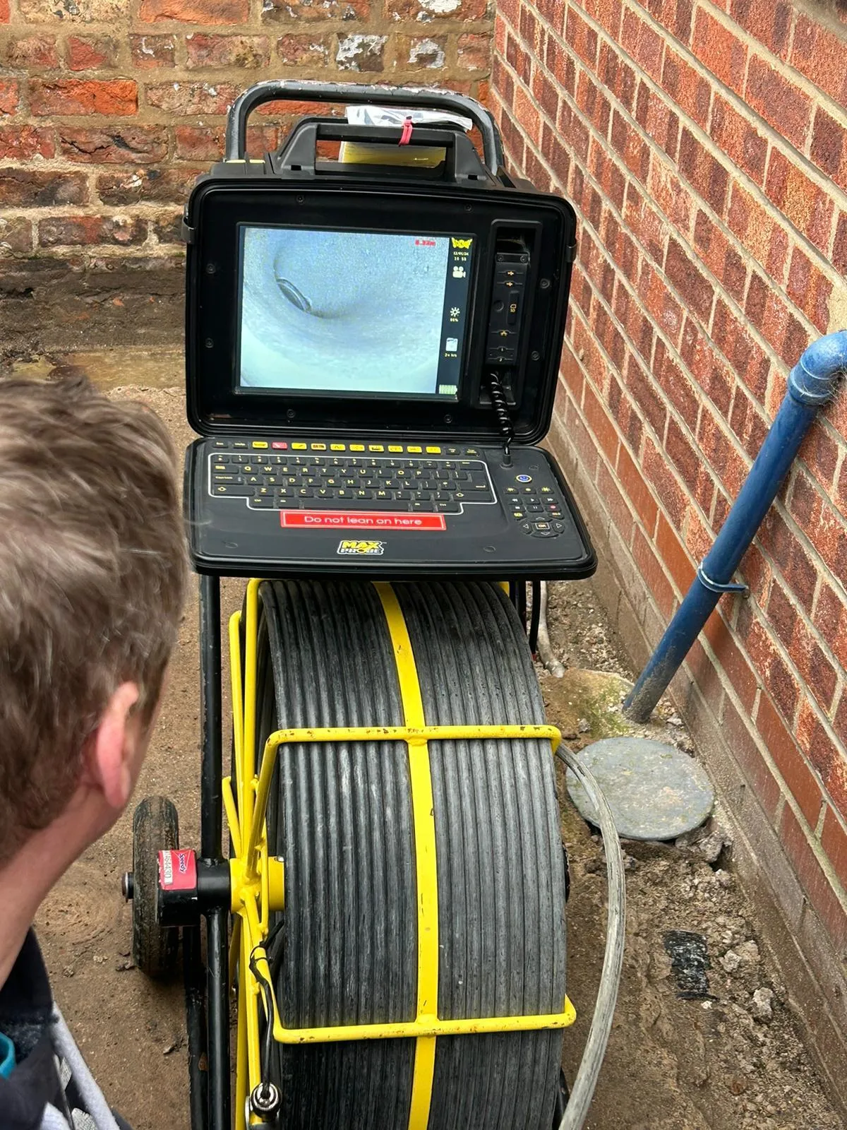 A Pest Control Harrogate technician conducting a professional CCTV drain survey and pest inspection to identify rodent activity.