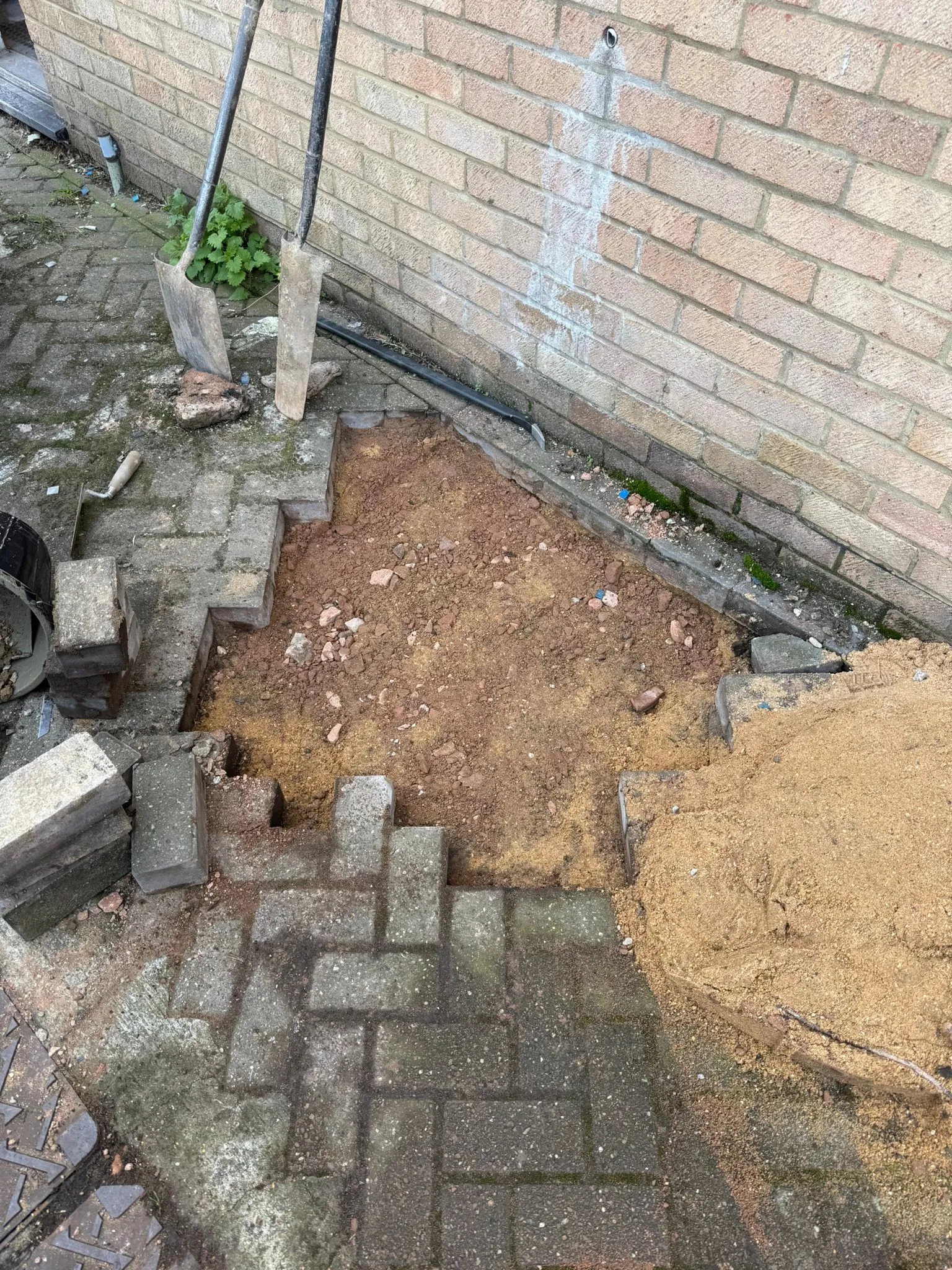 Excavation of block paving for drainage repairs by Drainage South Ltd