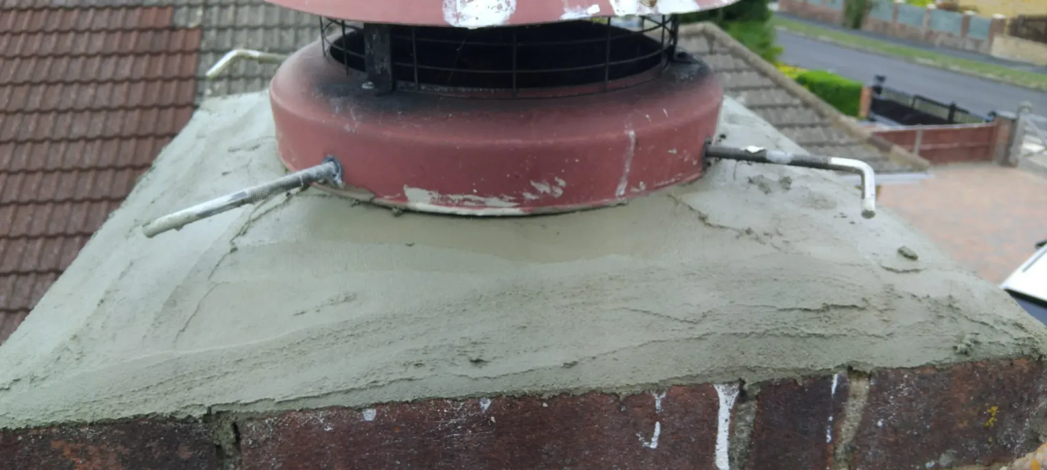 Fresh cement flaunching and cowl fitted during chimney stack repairs in Slough