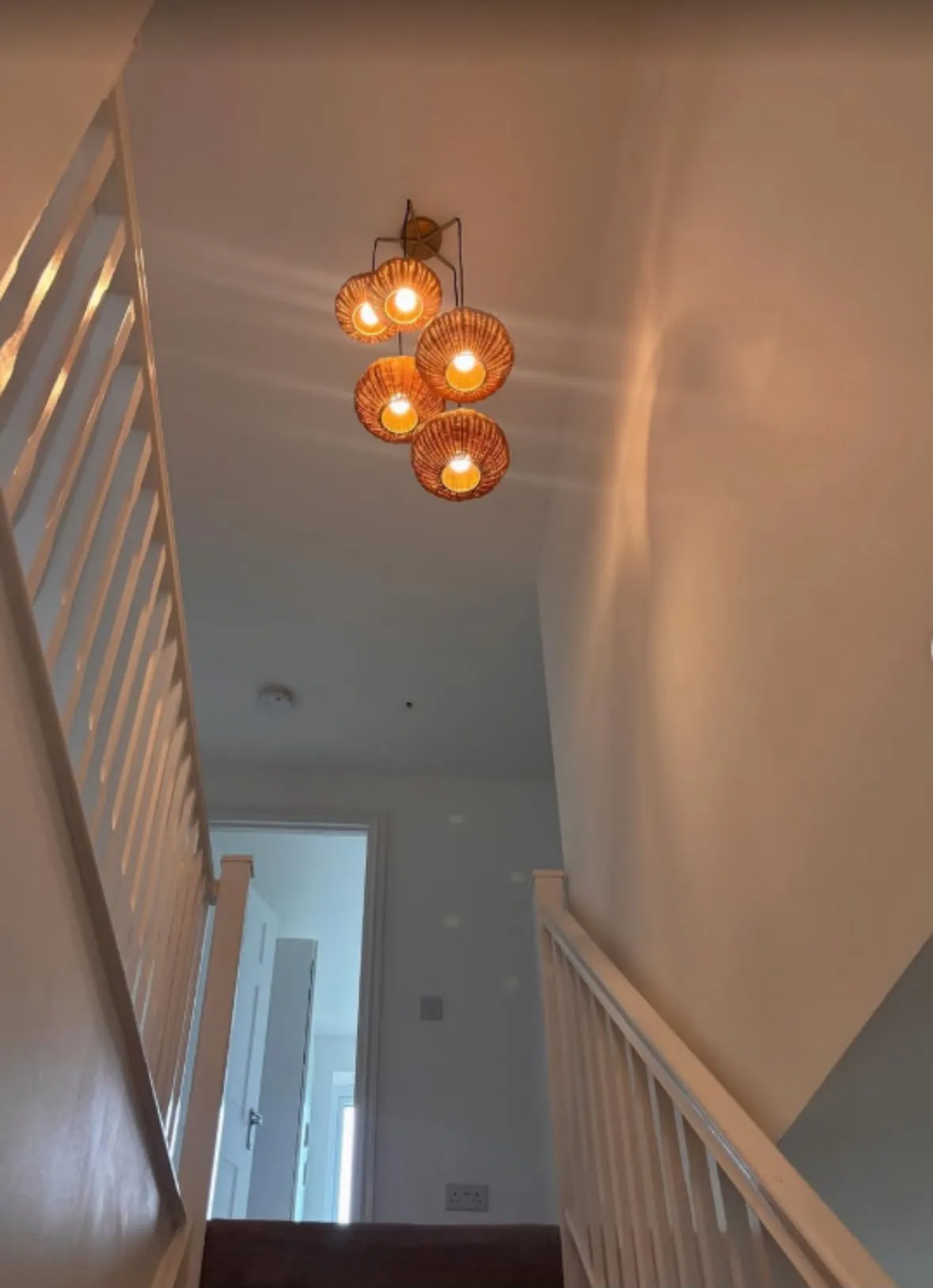 Modern cluster pendant feature light installed above a staircase landing in a residential property