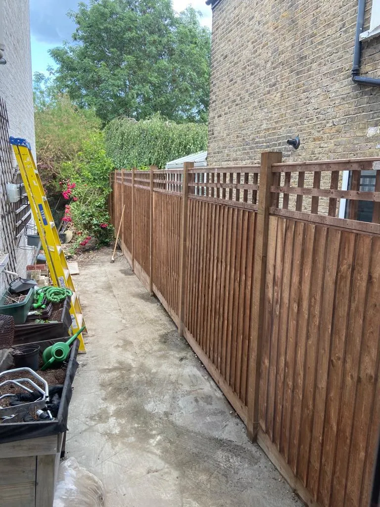 Expertly installed wooden garden fencing with trellis topping by Prestige Home Improvements in South-East London.