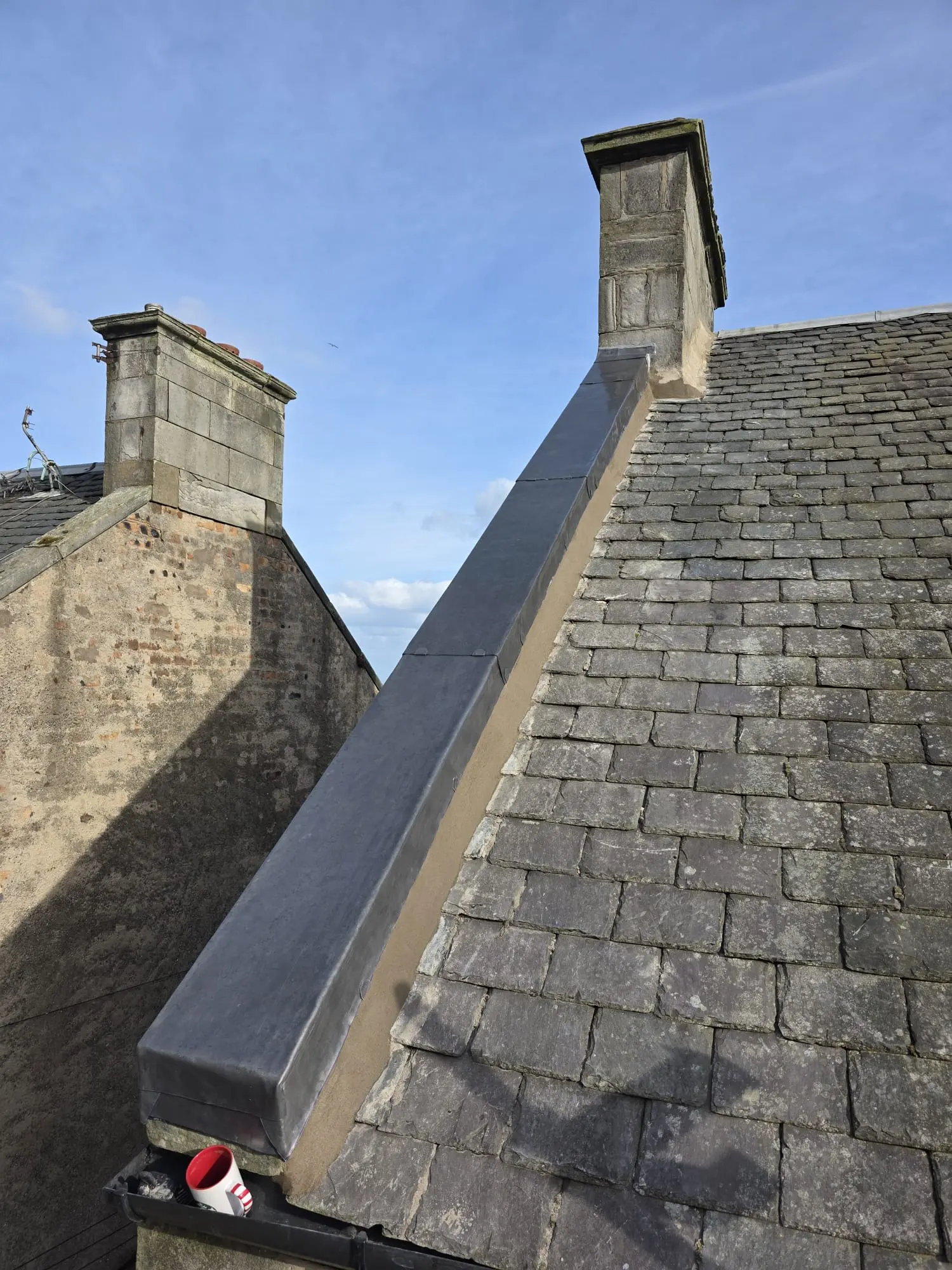 Newly installed lead flashing and capping on a traditional slate roof in Fife