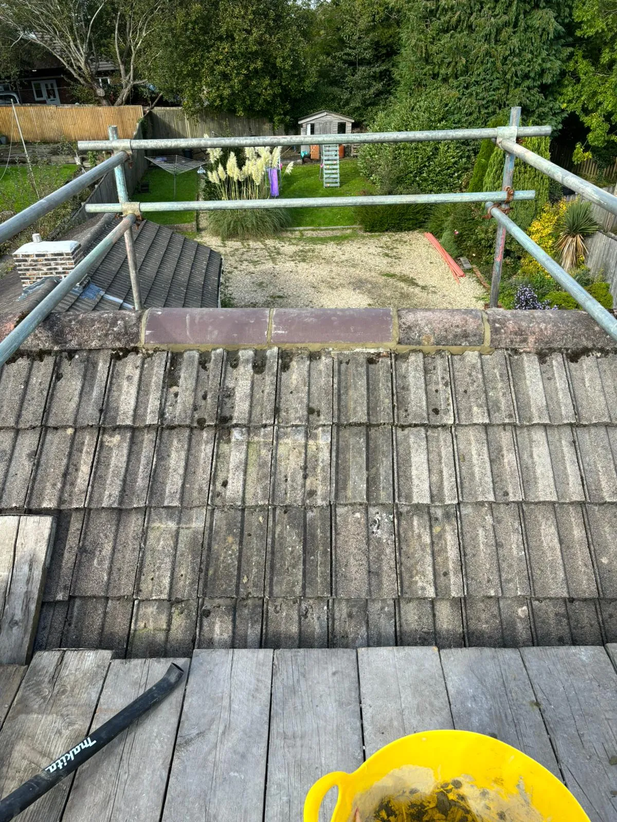 Tiled roof repair with new ridge tiles and scaffolding in Gloucestershire
