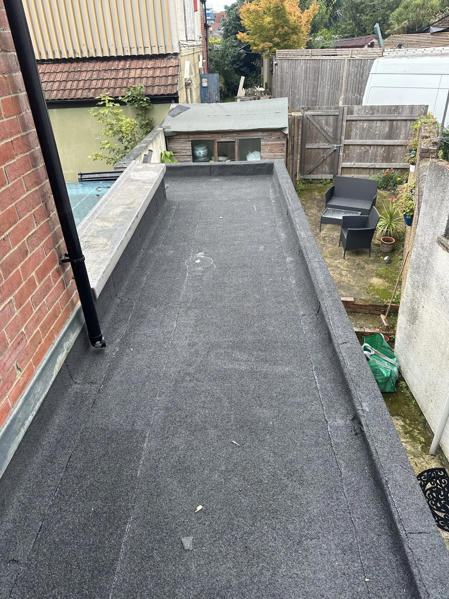 Grey torch-on felt flat roof on a residential extension