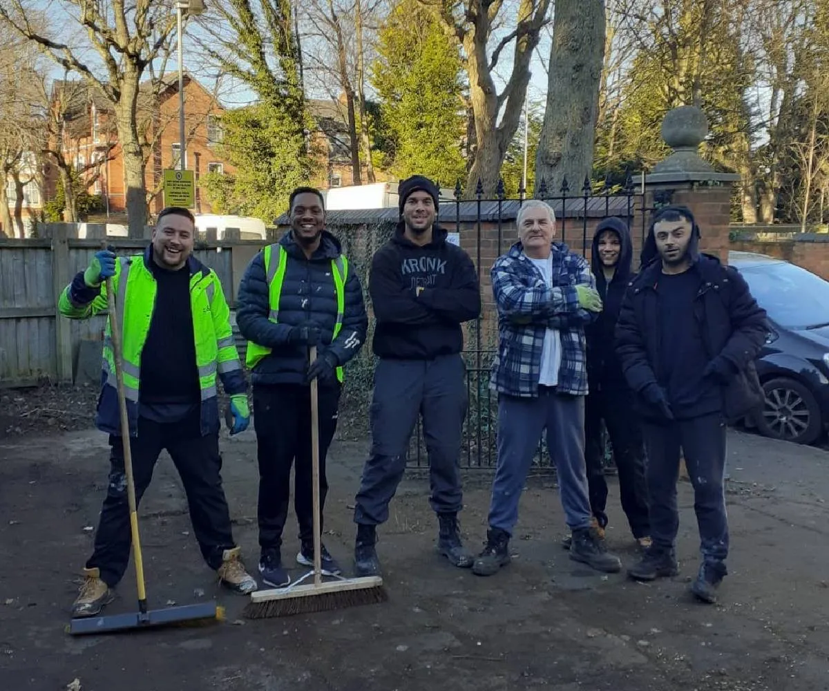 J&J Clearance and Gardening Ltd team on site in Birmingham with brushes and safety workwear