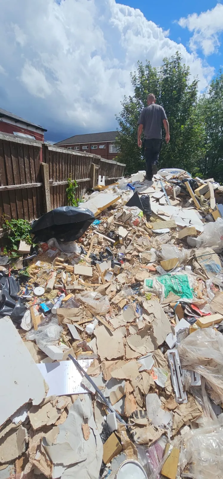 Large pile of builders waste, plasterboard, and renovation rubble awaiting clearance in Birmingham