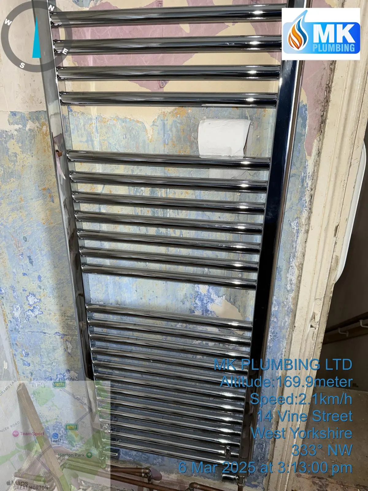 Professional installation of a chrome heated towel rail by MK Plumbing LTD in a residential property.